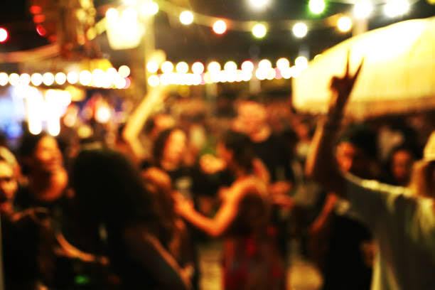 Blurred Background Of Many People Had Fun At A Beach Party. Festive Concept.